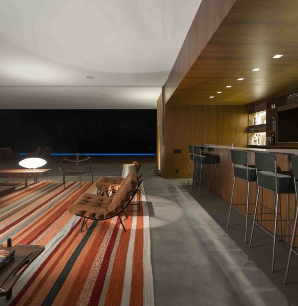 Marcio Kogan's Casa Lee Concrete House- bar living with wood clad and down lit outdoor views