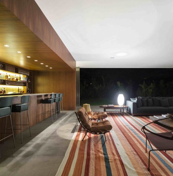 Marcio Kogan's Casa Lee Concrete House- bar living wood clad and down lit outdoor