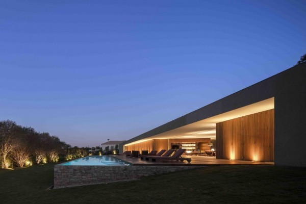 Marcio Kogan's Casa Lee Concrete House- exterior with view of pool and indoor outdoor living