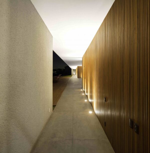 Marcio Kogan's Casa Lee Concrete House- wood clad hall up lit