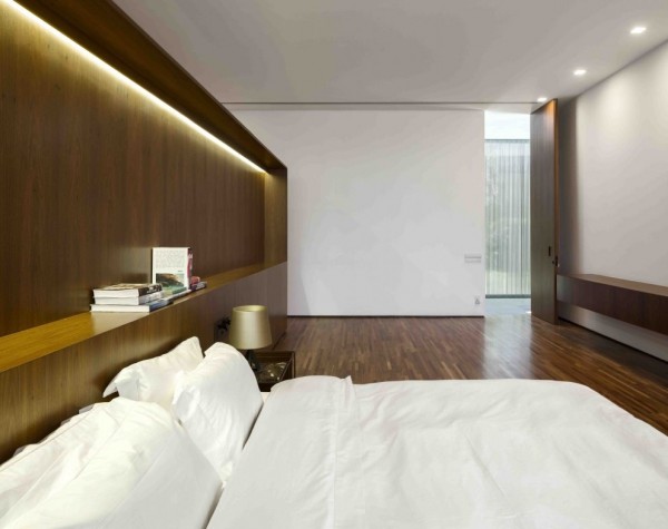 A minimalist approach in the bedrooms allows the angular nature of the space and the richness of the wood to shine, which is of course, aided by recessed fluorescent lighting above the bed, making for optimum night time reading in the happy absence of a television. Square down lighting is preferred to the usual circular look, which also plays on the greater aesthetic.