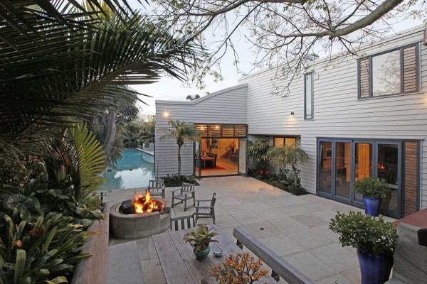 Sotheby's Auckland House- outdoor living with fire pit tropical gardens and pool