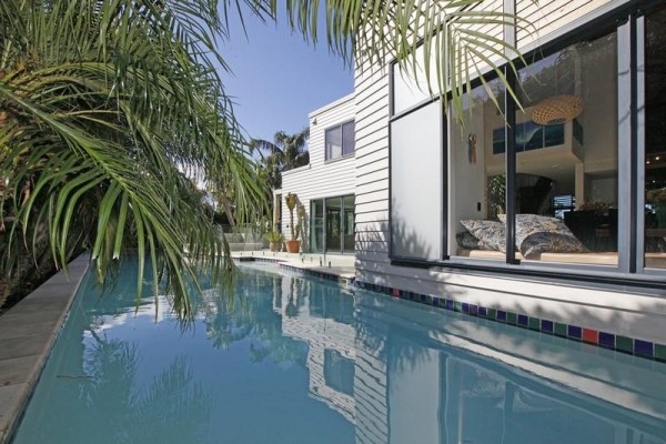 Sotheby's Auckland House- pool with overhanging palm fronds and view from window seat