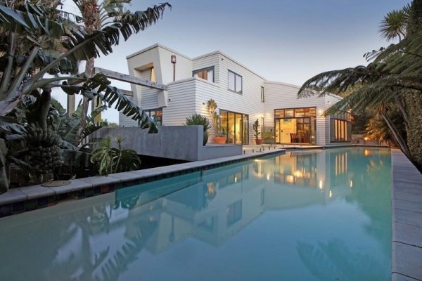 Sotheby's Auckland House- view of modern facade from pool house exterior
