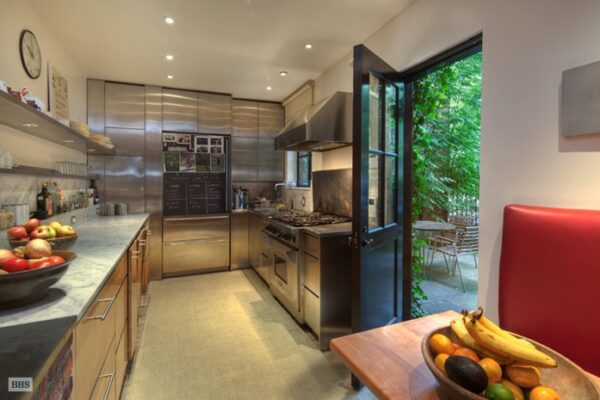 The small kitchen but well-appointed kitchen boasts state-of-the-art appliances in stainless steel, marble countert ops and svelte modern cabinetry.