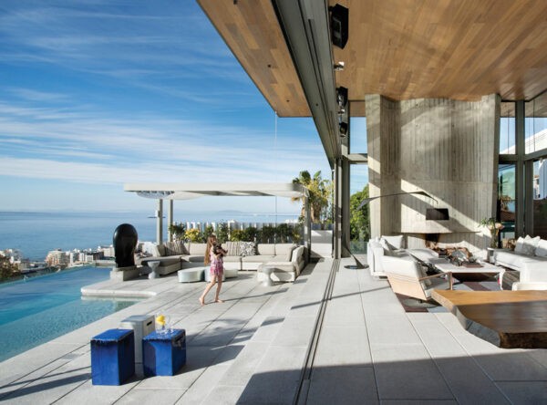 The west facing pool is oriented with expansive views of the vivid blue waters of the sea below.