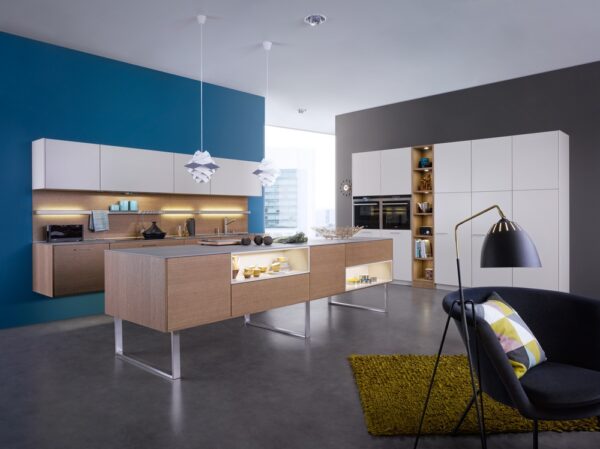 white and blonde wood kitchen blue feature wall