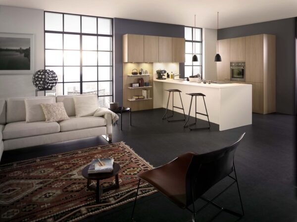 white kitchen island with blonde wood and pendant lights