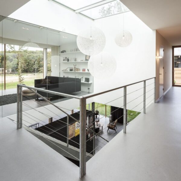 The villa's stairwell is at its center with a large skylight flooding light down through the levels.