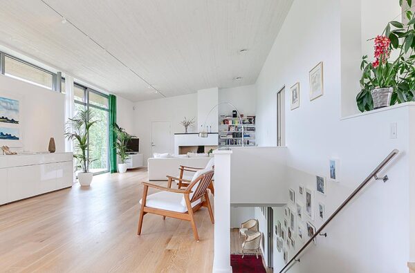 A semi-hidden stairway leads to the villa's lower level. An open living area can be seen to the left with ample space to accommodate entertaining large groups.