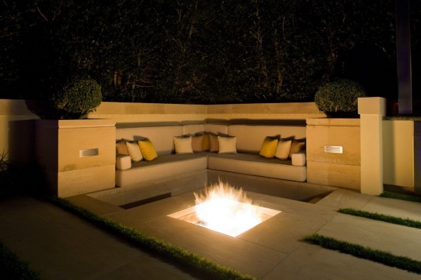 Fire pits such as this one are an essential of any outdoor living area. This one boasts an in-ground design surrounded by built-in seating.