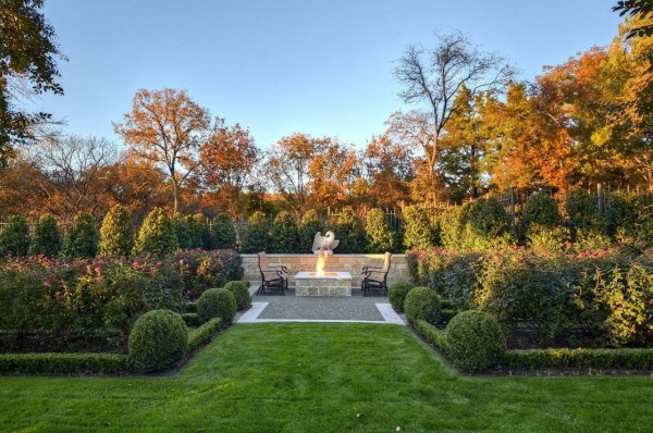 This formal outdoor sitting area with fire feature could easily work for any traditional residence.