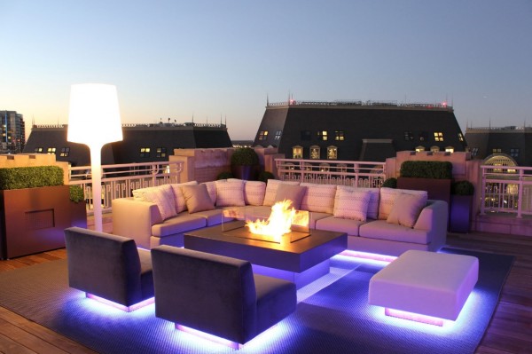Modern outdoor furniture appears to float on dramatic up-lights.