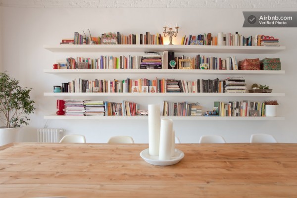 Bookshelves span the wall in the dining area creating a library feel.