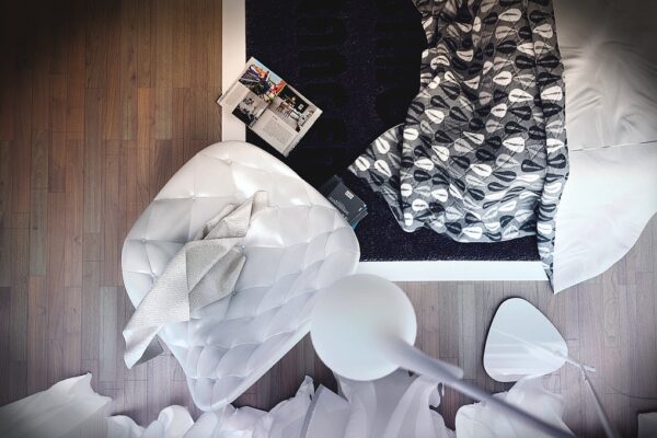 Pattern and texture are plentiful in this contemporary bedroom with stylized wood wall treatment, and diamond pattern carried from headboard to bedding to tufted modern leather chair.