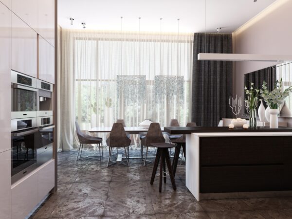 This view from the kitchen shows the size of the large open space through to the dining room. Twin waterfall lights add interest whole the rough stone floor tiles amp up the texture in the space.