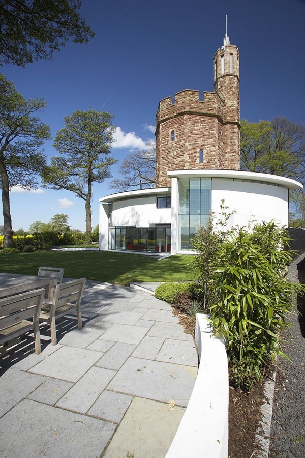 Concrete pavers lead the way to the tower house from the garden.