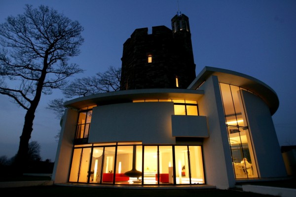 The tower's exterior is resplendent when all rooms are alight in the night.