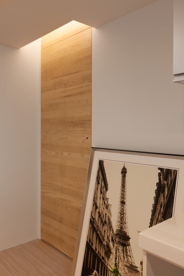 Finally, the lighting in the space is such that the apartment feels warm and welcoming even in the dead of night. Recessed lighting is built into the walls and ceiling rather than relying on lamps and light fixtures. This choice integrates with the apartment's clean lines and reduces clutter.