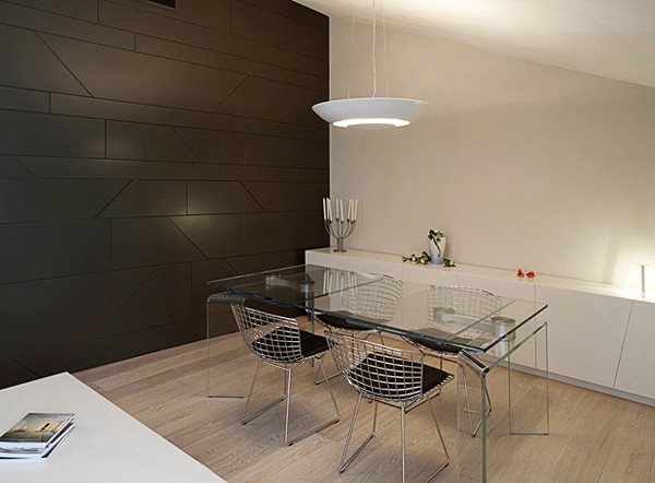 An additional dining area off the living room features wire mesh chairs and a acrylic table.