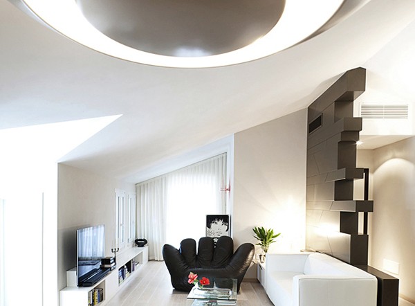 The sharply angled ceiling and angled walls of the living room offer striking architectural elements.