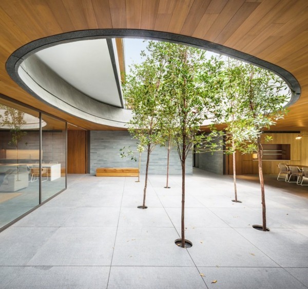 The huge central courtyard features an open air oculus and six willow trees for a minimalist look.