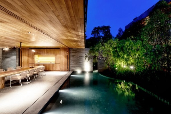 The shallow pool adds a mysterious element to the outer living areas as it winds around the house.