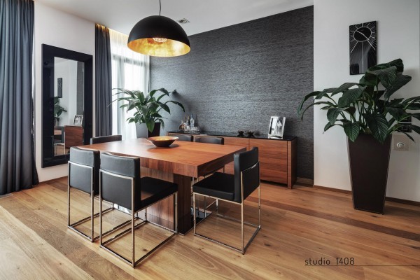 The rich woods and lush greenery really bring a natural feel to this dining space. A textured accent wall brings pop, without straying from the neutral tones.