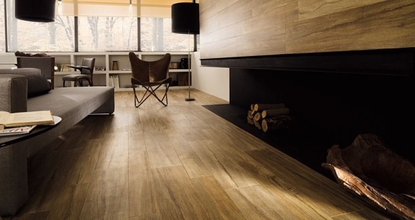 The elongated, built-in fireplace is surrounded by natural wood panels that also cover the floor.