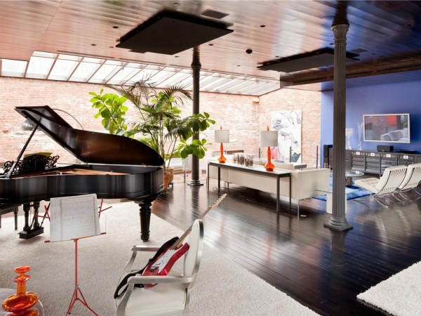 The sixth floor also has a music room hosting both classic and contemporary instruments. Another more casual living room area is also seen with yet another skylight.