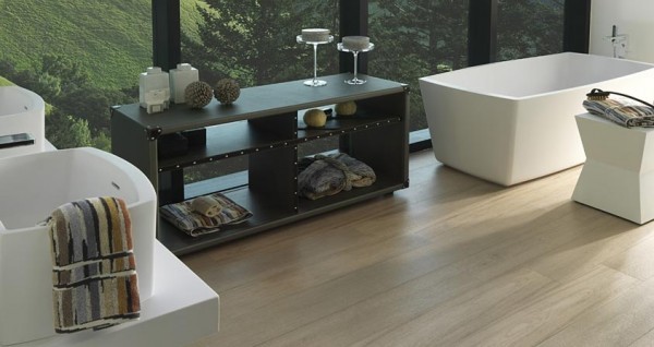 Hardwood isn't seen as much in bathroom designs, but it brings a natural feel to this one with the stand alone tub and cabinets, and the over-sized vessel sinks.