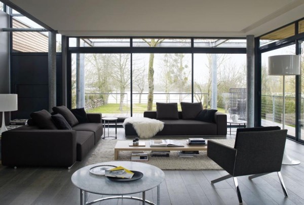 Another sectional sofa is broken up to create separate seating areas in this living room. A similar colored chair with chrome legs was brought in to provide even more seating.