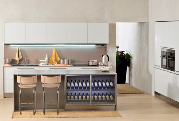 This classy kitchen space has a full wine rack built into the island. It adds to the aesthetics of the space and provides a show piece.