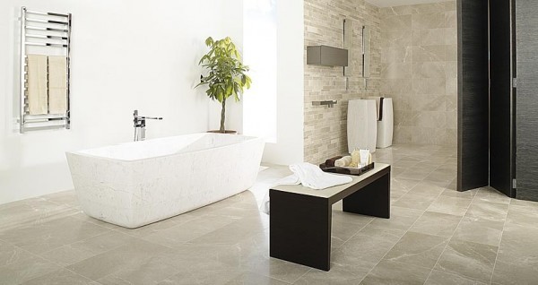 This bathroom has a natural environment with stone walls and a mosaic tile-covered stone wall housing the sinks and mirrors. The large freestanding tub is a perfect fit in this large bathroom.