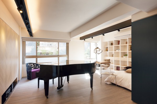 Because the layout and design of the bedroom/office space was done so resourcefully, they were able to add a black piano to the room, which even though is quite large, still doesn't take away from the space or make it appear too small.