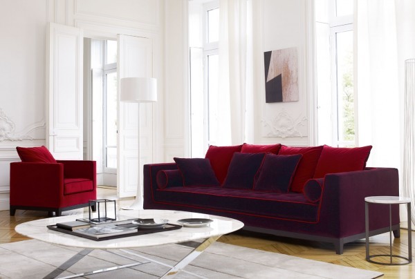 This design is for someone who is not afraid of color. The furnishings can be done in various colors, but in this space the jewel toned red and purple fabrics really jazz up a  monochromatic space.