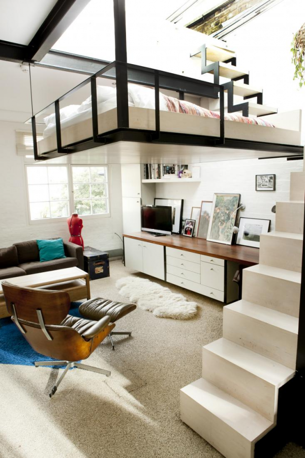 The first thing you notice in this combination living area is of course the bed suspended from the ceiling. Accessible by narrow staircase off to the side, this is really saving space because fitting a bedroom would have made for a closet sized living room. Not only does the bed conveniently suspend from the ceiling, but it is underneath a large, retractable glass panel that provides access to the rooftop terrace.