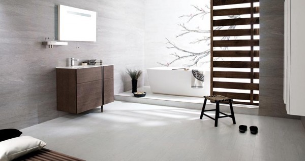 Open and beautifully tiled bathroom space with a stand alone tub.