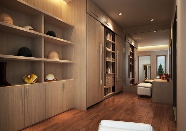 This massive walk-in closet has perpendicular wooden patterns from the hardwood floors and the cabinets and shelving. The contrast continues in the different shades of the wood.