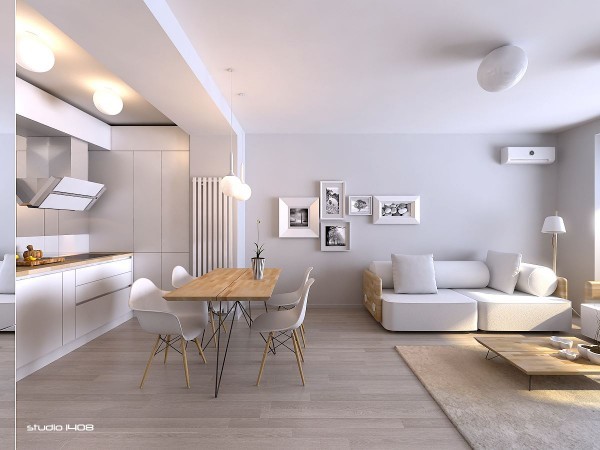 White is often considered the supreme color choice for a modern and minimal design and this living space exemplifies that. The wood used is in a very light shade and the only slight touch of darkness can be seen in the window and door frames. The wall art keeps with the white color scheme and adds a touch of nature to the room.