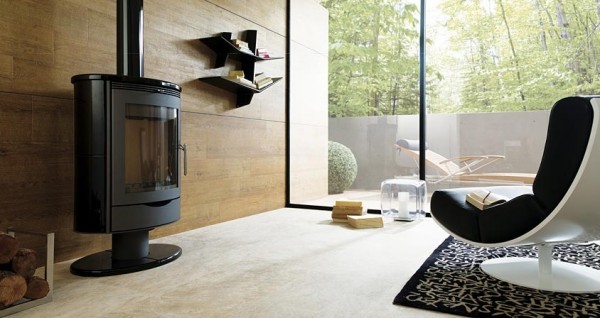 A warm, rustic living room space with wood paneled walls and stone flooring.