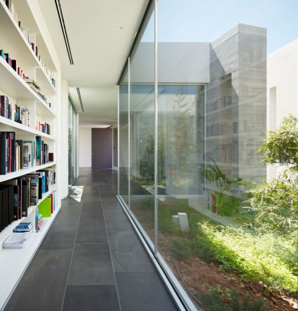 Whether a bookworm or a professional with a home office, this glass wall looking out onto an interior garden from a massive built-in bookshelf is sure to insprie envy.   The simplicity of this minimalist house makes it the perfect place to live a Zen existence while still having the beauty of modern conveniences at your fingertips.