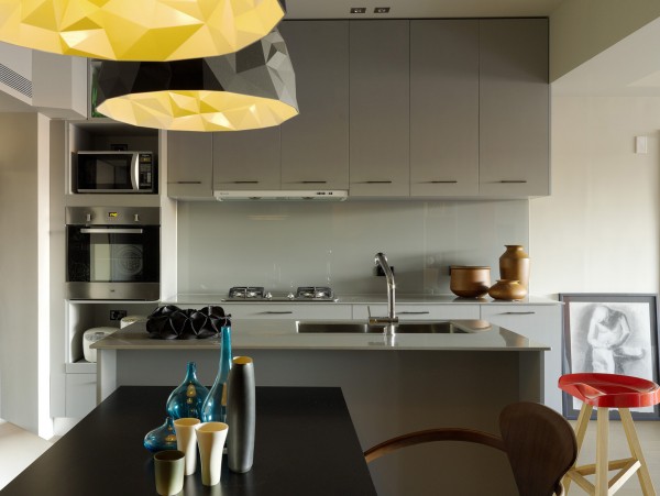 The kitchen is compact but has all the necessities as well as smooth, clean lines that make it an inviting place to prepare any meal. Geometric light fixtures are fun as well as flattering as they softly scatter wattage.