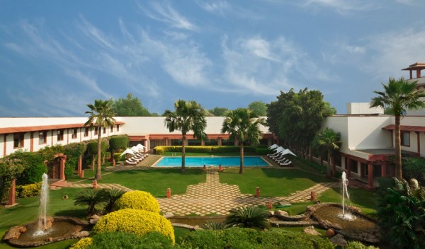 A clear blue pool flanked by palm trees is reminscent of old Hollywood glamour as much as it is of Indian vacations.