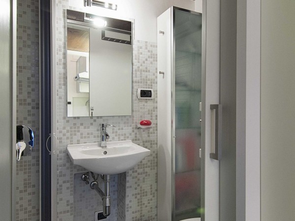 The bathroom is small but gleaming with just enough space for comfortable showering and daily rituals.