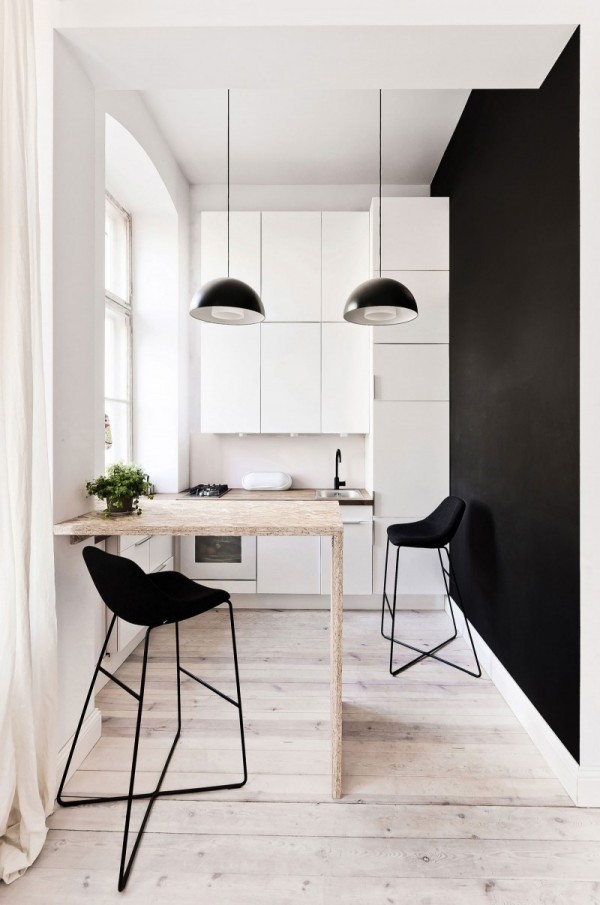 The small kitchen again makes use of the high ceilings with storage space going all the way up.