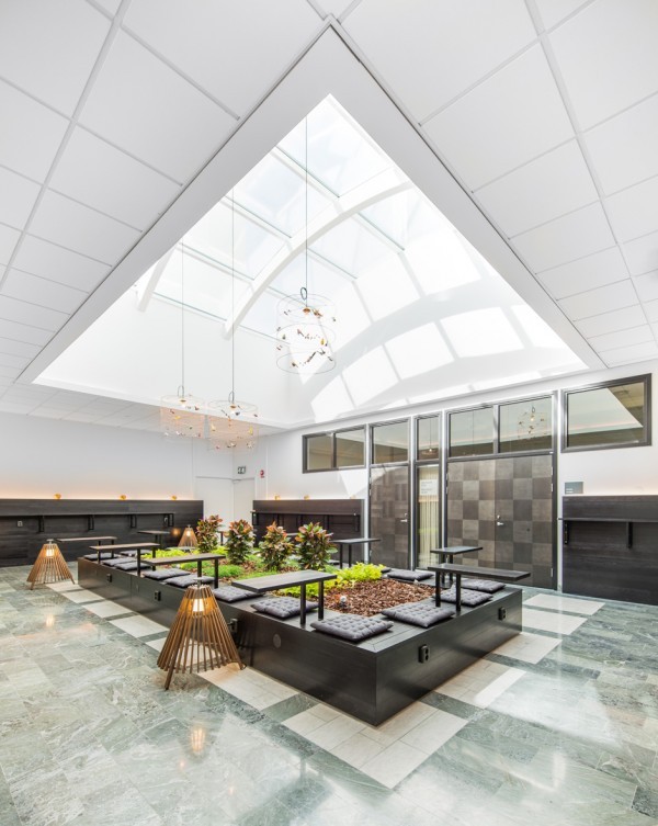 This central atrium is a beautiful gathering space for both work and relaxing. Sun streams in through the ceiling all day and the greenery nestled in the center can offer respite from chilly Stockholm winters.