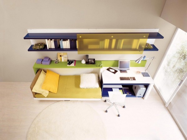 The floor shelf can easily slide underneath the desk surface to make room for this hidden bed.