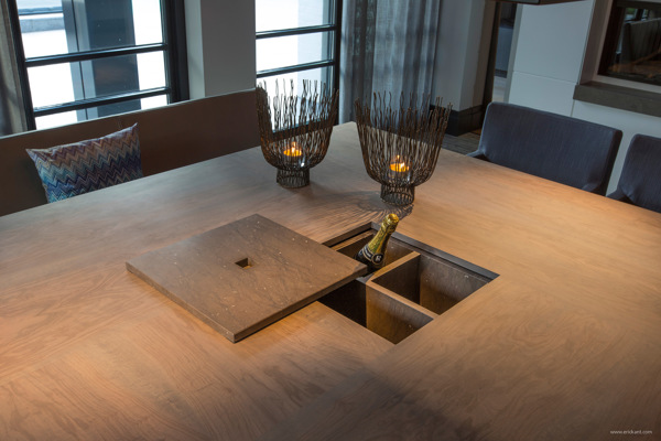 The concealed wine storage in the center of this dining table is one of the cleverest designs we have seen. When not in use, it could easily be covered with a cloth or serving platter, but open it up at dinner parties and guests are sure to be amazed and envious.