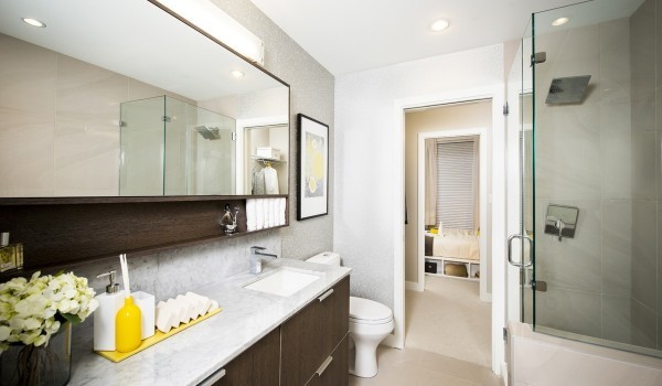 The right use of color can affect all the senses. Here, tiny bits of lemon yellow seem to drift up into the air, scenting this bath with citrusy goodness while still letting black and white tile create an easy, cleanable, transformable room.